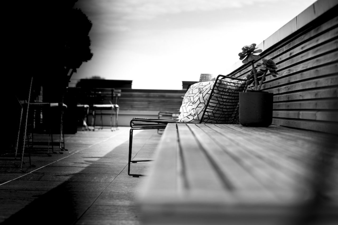A black and white picture of a rooftop terrace.
