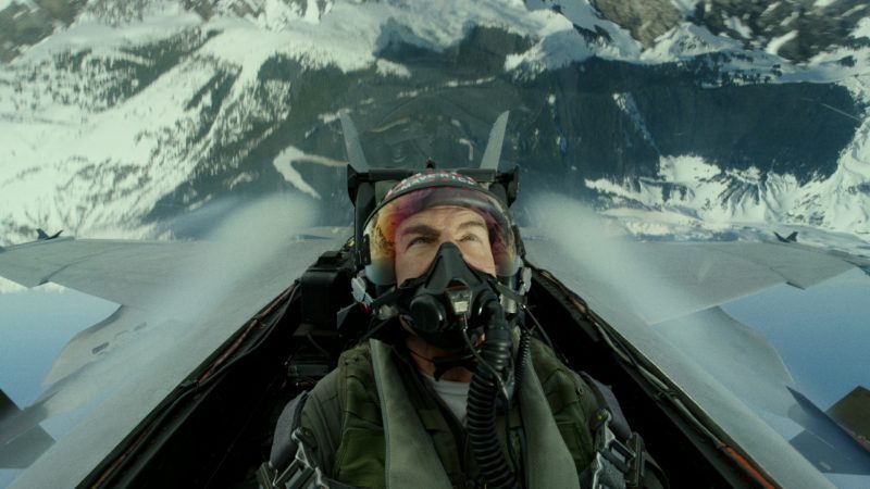Tom Cruise is sitting in a plane during a scene of Top Gun: Maverick.