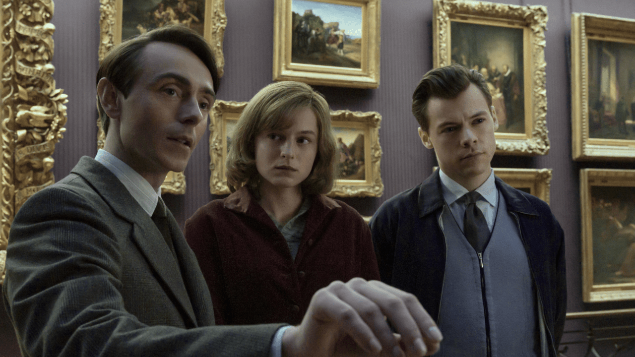 The characters of My Policeman are featured in a museum, with plenty of pictures and frames behind them.
